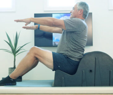 An older man using the CoreBella spine corrector