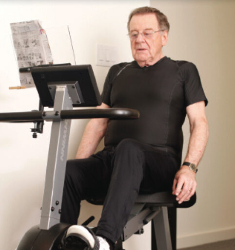After surgery to remove benign spinal tumors, John returned to activity with the help of his personal trainer, his rehabilitation program includes cardio on the bike and core exercises to strengthen his spine and make his back more resistant to injury